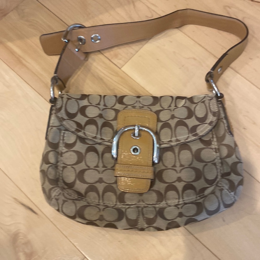 Brown and tan coach bag 6” tall without handle and 11” wide